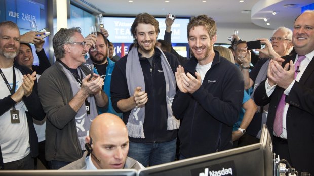 Atlassian co-founders Mike Cannon-Brookes and Scott Farquhar watch as their company's shares open on the Nasdaq.
