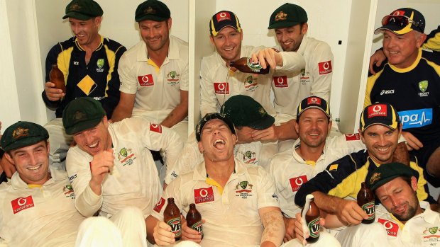 David Warner (front) has a VB beer poured on him by then-captain Michael Clarke as the team celebrate their win after day three of the Third Test in 2012.