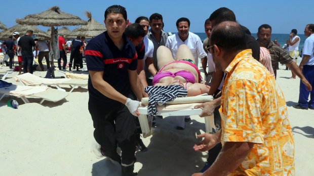 Tunisian medics carry a woman on a stretcher in the resort town of Sousse, a popular tourist destination 140 kilometres south of the Tunisian capital following a shooting attack.