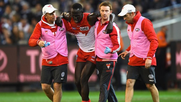 Strain: Aliir Aliir remains a chance to play against the Bulldogs despite having to be helped from the field during the Swans' preliminary final victory over the Cats.