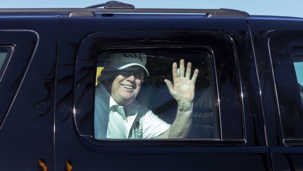 President Trump waves to supporters on the way to his Mar-a-Lago estate on December 28.