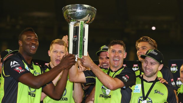 Drought breaking: Thunder players celebrate with the Big Bash trophy.