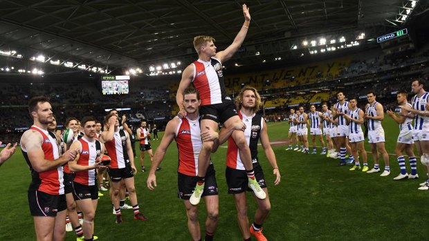 Final farewell: Josh Bruce (left) and Sam Gilbert see out their retiring club captain after the Saints last home game for 2017 at Etihad Stadium.