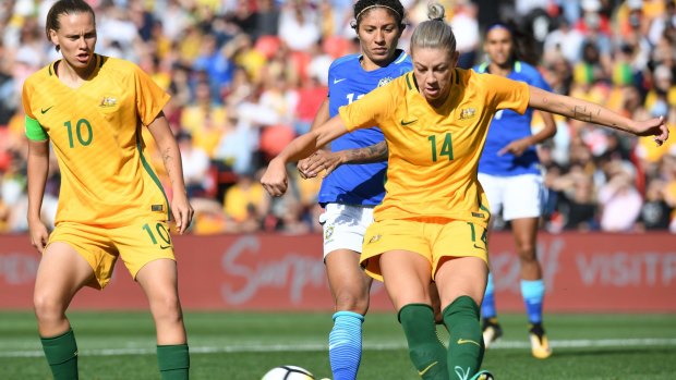 Australia's Alanna Kennedy (right) clears the ball against Brazil in their recent friendly in Sydney.