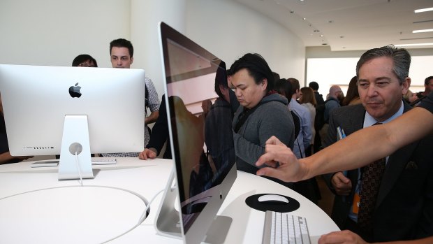 Attendees inspect the new iMac with retina display.