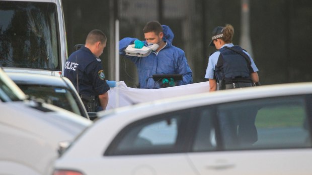 Forensic teams examine the scene of the siege, at Ingleburn industrial complex.