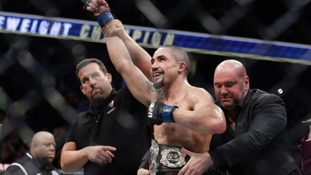 Hometown hero: Robert Whittaker, seen here being presented with his interim middleweight title, is the favourite to headline UFC 221. 