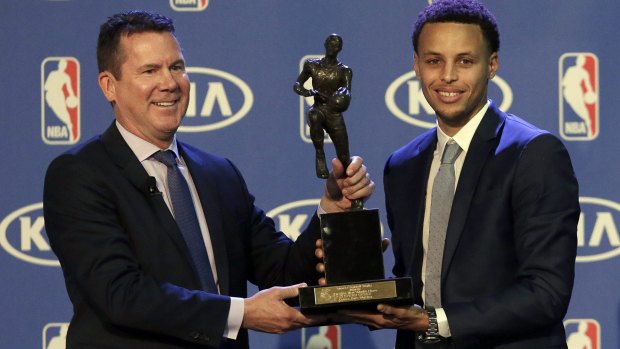 Top value: Golden State Warriors guard Stephen Curry (right) with the MVP trophy.