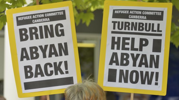 Signs at a rally in Canberra urge support for Somali woman and  Nauru asylum seeker Abyan who claims to have been raped, was flown to Australia for an abortion, and then flown back without having had the procedure.