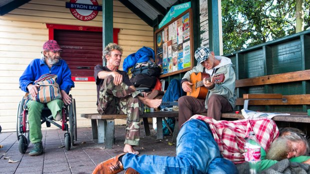 Homeless men at the main bus shelter in Byron Bay. 