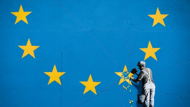 A mural depicting a European Union (EU) flag being chiseled on the side of a disused building near the ferry terminal in Dover.