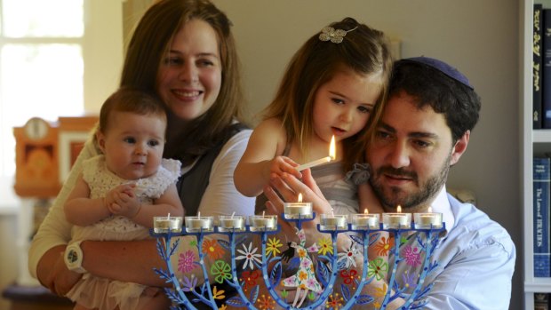 Happy Hannukah: Rabbi Alon Meltzer, his wife Linsay and their two daughters celebrate Hanukkah at their home in Barton. 