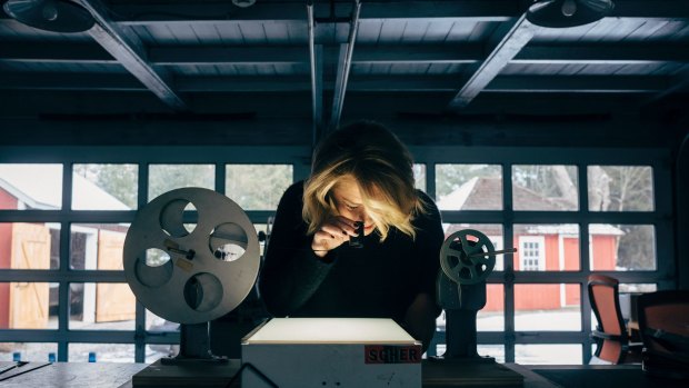 Bonnie Siegler looks at 16mm film of Marilyn Monroe, shot by her grandfather, on a reel-to-reel at her home in Connecticut.