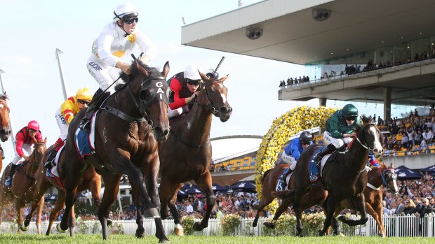 Golden moment: Tommy Berry (left) rides Vancouver to victory in the Golden Slipper.