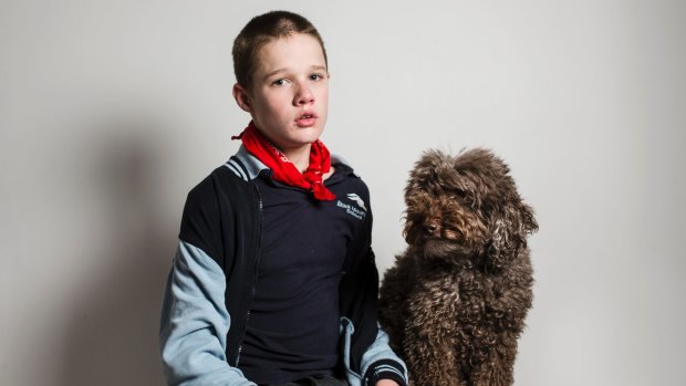 Logan, pictured with his therapy dog Simi, has autism and requires one-on-one care at Marymead's respite service.