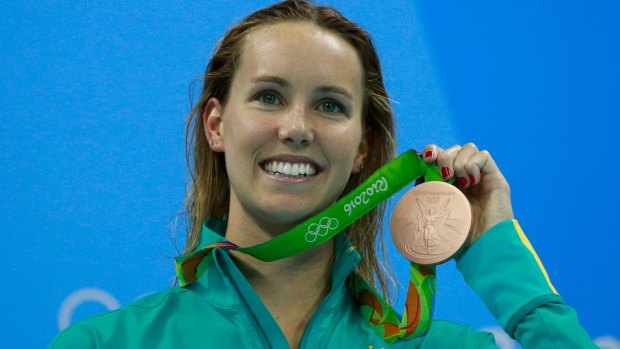 Australian swimmer Emma McKeon holds her Rio bronze medal. Many have been returned because of rust.