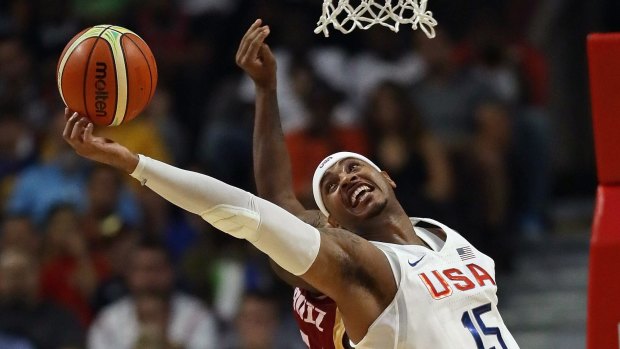 International stalwart: Team USA veteran Carmelo Anthony grabs a rebound against Venezuela during a pre-Olympic exhibition game in Chicago.