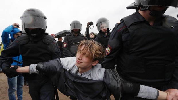 Police detain a protester during a rally in St Petersburg.