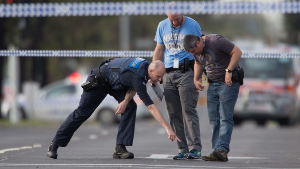 Detectives check the scene where a patrol car came under fire in Hoppers Crossing. 