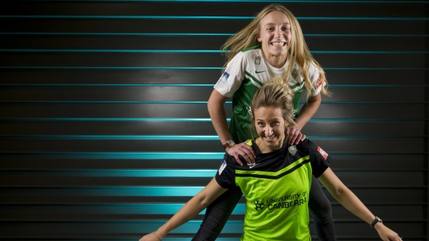 Nickoletta Flannery (jumping) and Grace Gill at the announcement University of Canberra will remain as front of shirt sponsor for W-League team Canberra United for another two seasons.