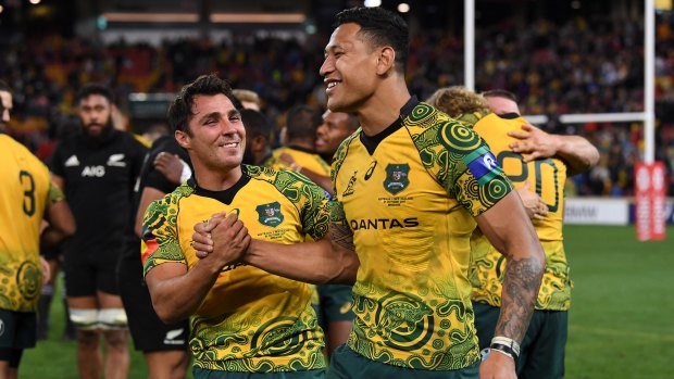 Nick Phipps and Israel Folau celebrate the Wallabies' win in the third Bledisloe Cup Test in Brisbane.