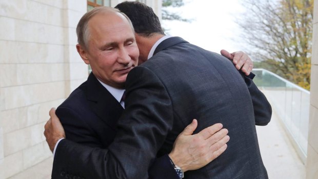 Russian President Vladimir Putin, left, embraces Syrian President Bashar Assad in Sochi on Monday.
