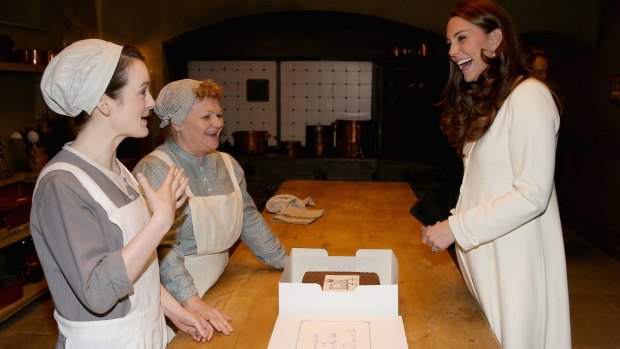 Lady of the House: Catherine, Duchess of Cambridge chats to actresses Sopie McShera and Lesley Nicol during a visit to the set of Downton Abbey.