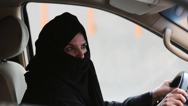 A woman drives a car on a highway in Riyadh, Saudi Arabia, as part of a 2014 campaign to defy Saudi Arabia's ban on women driving. 