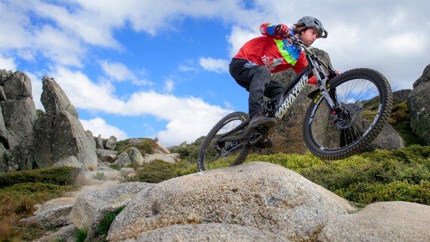 Tim Windshuttle hits a jump with speed on Thredbo's All-Mountain Trail.