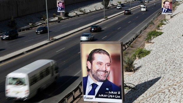 Posters showing Lebanese Prime Minister Saad Hariri with Arabic that reads, "No happiness without you Saad," hang along the airport highway, in Beirut.