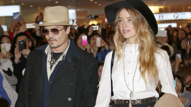 Amber Heard and Johnny Depp, pictured in 2015, will settle their divorce case.