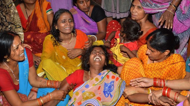 An Indian widow (centre) is comforted by relatives and friends after the death of her husband on the outskirts of Patna on Tuesday, after a new 7.3 earthquake and several powerful aftershocks hit neighbouring devastated Nepal. 