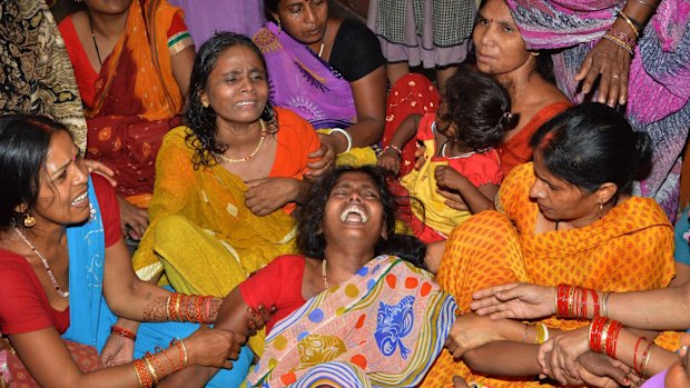 An Indian widow (centre) is comforted by relatives and friends after the death of her husband on the outskirts of Patna on Tuesday, after a new 7.3 earthquake and several powerful aftershocks hit neighbouring devastated Nepal. 