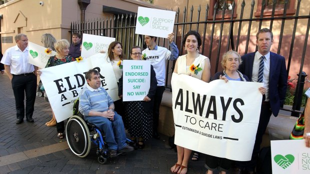 Opponents of the bill standing outside State Parliament on Thursday.