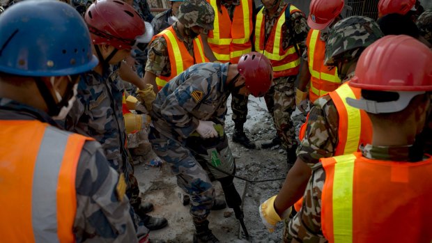 Nepalese Army work to try to dig up a little boy believed to be in the rubble of a Kathmandu house that collapsed following a second major earthquake on Tuesday.