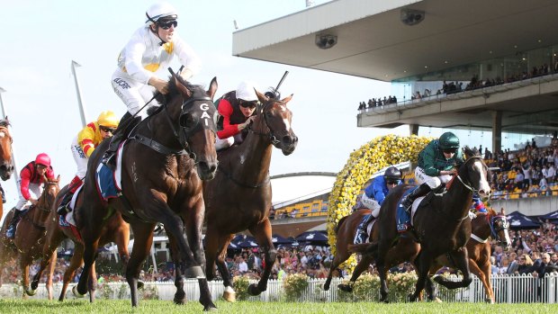 Golden moment: Tommy Berry (left) rides Vancouver to victory in the Golden Slipper.