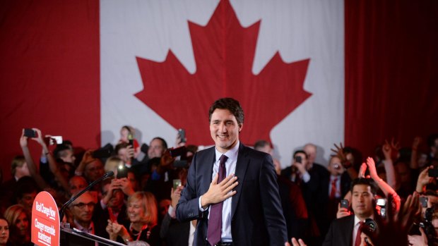 Victorious Liberal leader Justin Trudeau stands on stage at party headquarters in Montreal