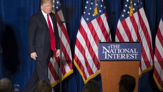 Something wooden in his walk?  Donald Trump approaches the podium to deliver a speech defanged of his usual rhetoric.