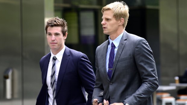 Lenny Hayes and Nick Riewoldt arriving at the County Court to support Stephen Milne.