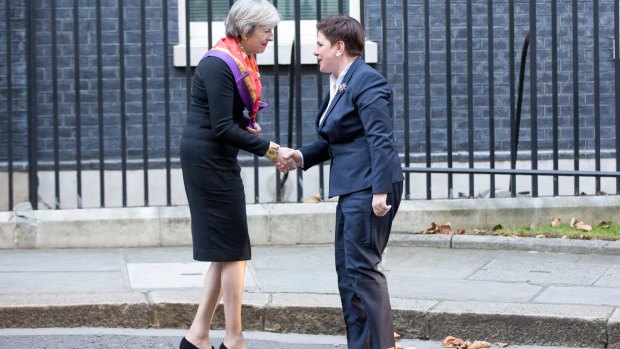 Theresa May, left, greets Polish PM Beata Szydlo in Downing Street in London, in the latest stage of her charm offensive aimed at smoothing Britain's exit from the EU. 