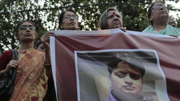 Bangladeshi social activists hold a banner displaying a portrait of blogger and author Ananta Bijoy Das during a protest against his killing, in Dhaka, Bangladesh.
