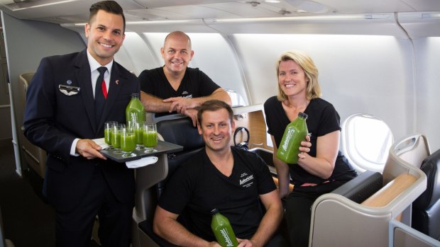 Flight Attendant Michael Cook with Botanica team Grant Swanepoel, Richard Magney and Nadia Watson on board a Qantas flight. 