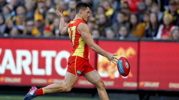 Gold Coast's Ben Ainsworth kicks a goal after a controversial 50-metre penalty against Kaiden Brand.