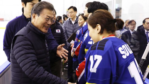 South Korean President Moon Jae-in greets members of South Korea's women's hockey team, some of whom oppose the proposal to form a joint team with North Korea.