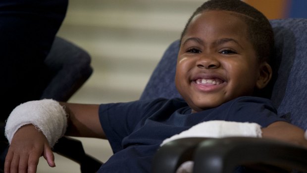 Double-hand transplant recipient Zion Harvey smiles during a news conference.