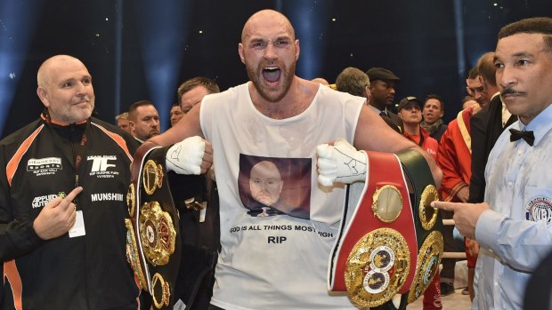 Ecstatic: Britain's new world champion Tyson Fury celebrates with the WBA, IBF, WBO and  IBO belts.