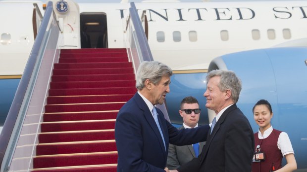 Max Baucus greets then US secretary of state John Kerry, left,  in Beijing in June 2016. The former ambassador has expressed frustration over the Obama administration's approach to China.