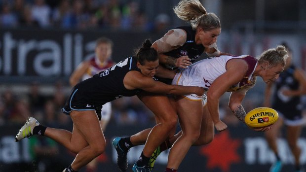 Blues Lauren Brazzale and Tayla Harris tackled the Lions' Nicole Hildebrand.