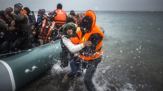 Refugees and migrants disembark on a beach on the Greek island of Lesbos in January.  