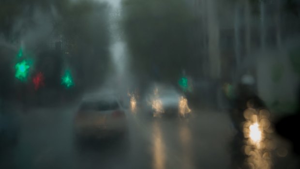 Cars drive in rain in North Sydney on Tuesday.